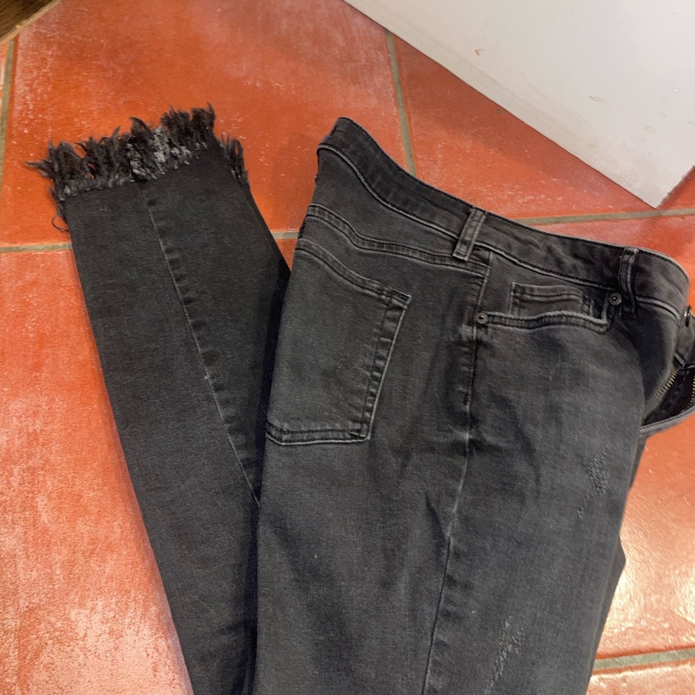 Like new womens ripped black washed jeans with fringe